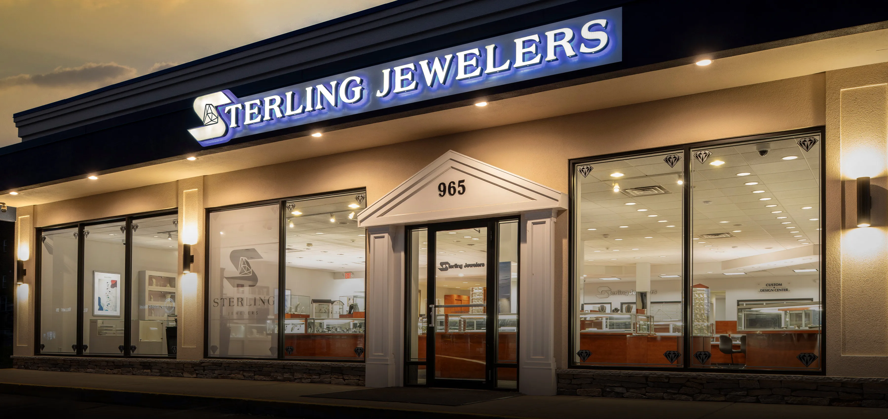Model wearing a gold chain necklace and hoop earrings, showcasing elegant jewelry.