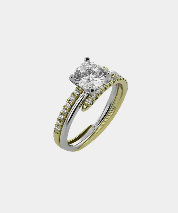 Elegant two-tone engagement ring with a large center diamond. Click to explore bridal sets at Sterling Jewelers.