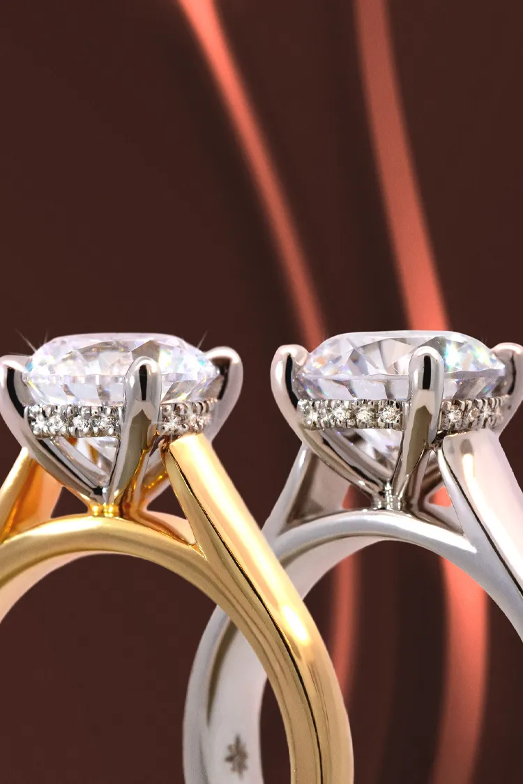 Two elegant engagement rings, one in yellow gold and the other in white gold, showcasing sparkling diamonds.