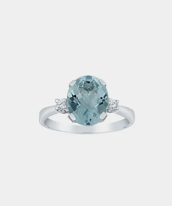 Aquamarine ring with diamond accents on a silver band.