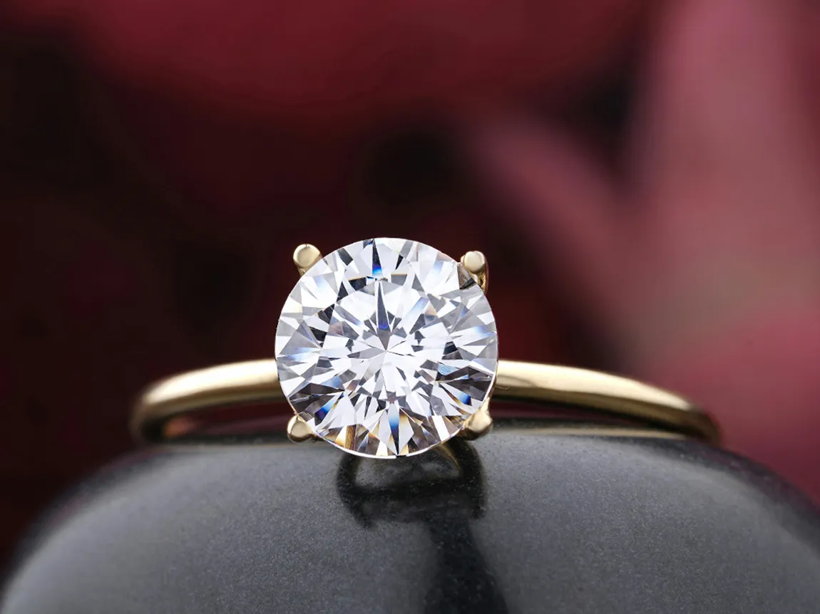 Elegant round diamond engagement ring set in a gold band.