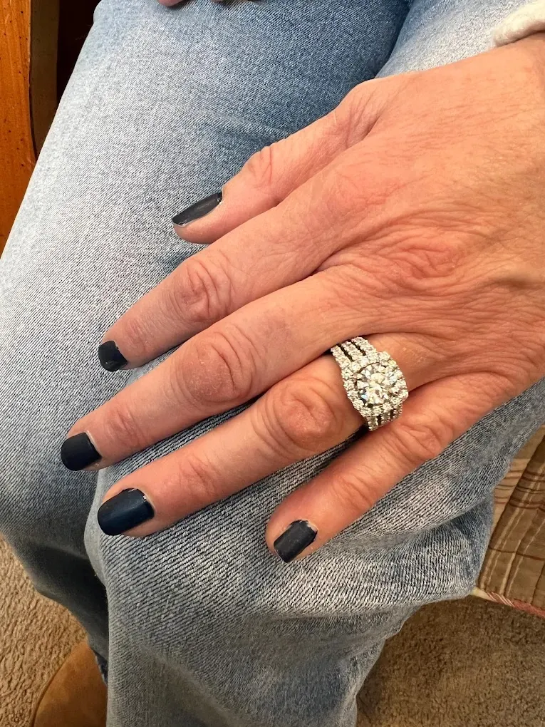 Elegant jewelry display featuring rings and a necklace with blue gemstones.