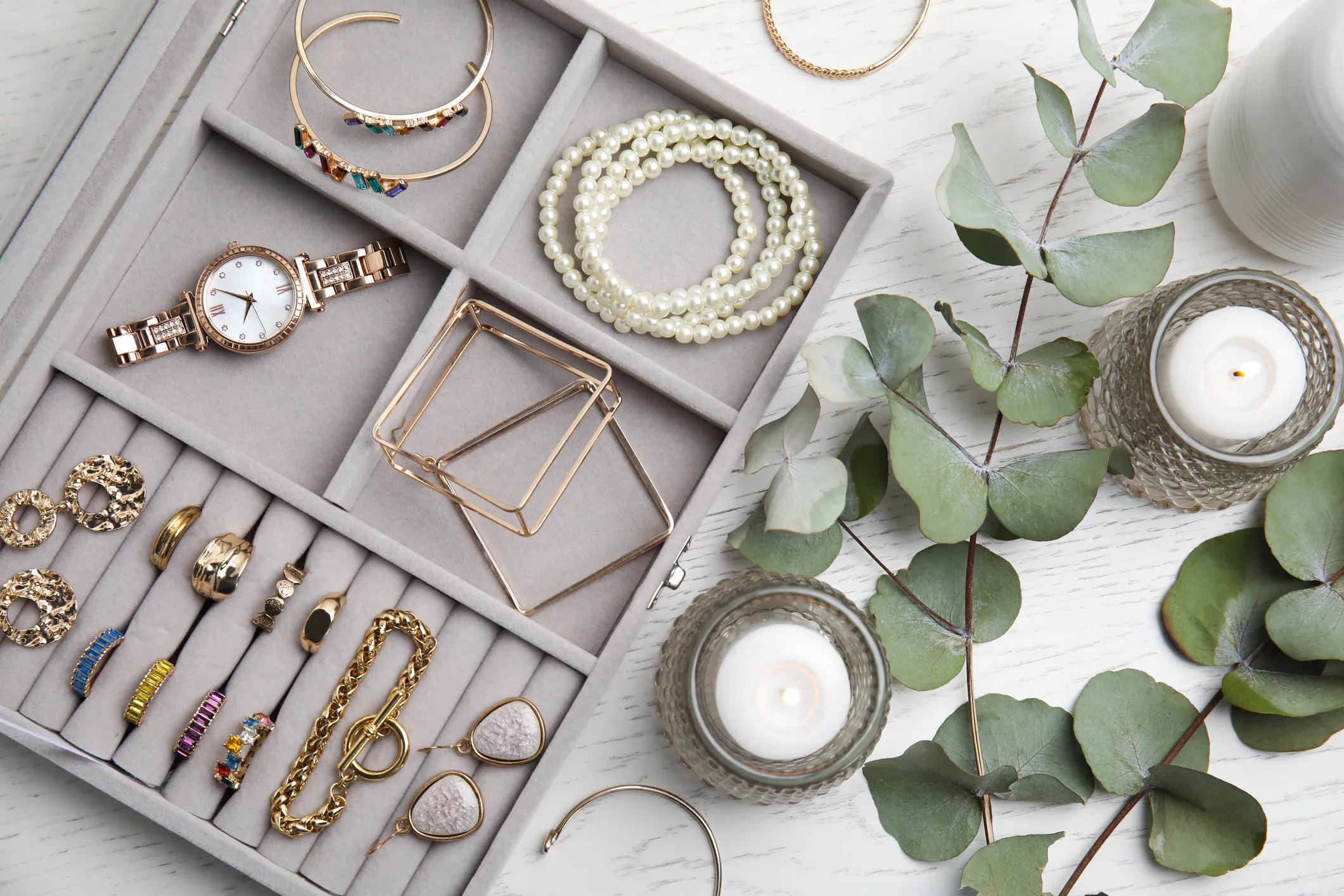 A jewelry box with assorted pieces, including a watch, rings, and bracelets. Shop all jewelry!