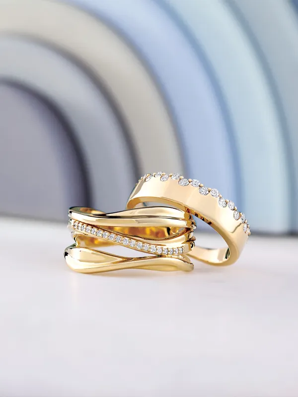 Two elegant gold rings with diamonds, displayed on a soft surface, against a pastel background. Click to explore more at Simones