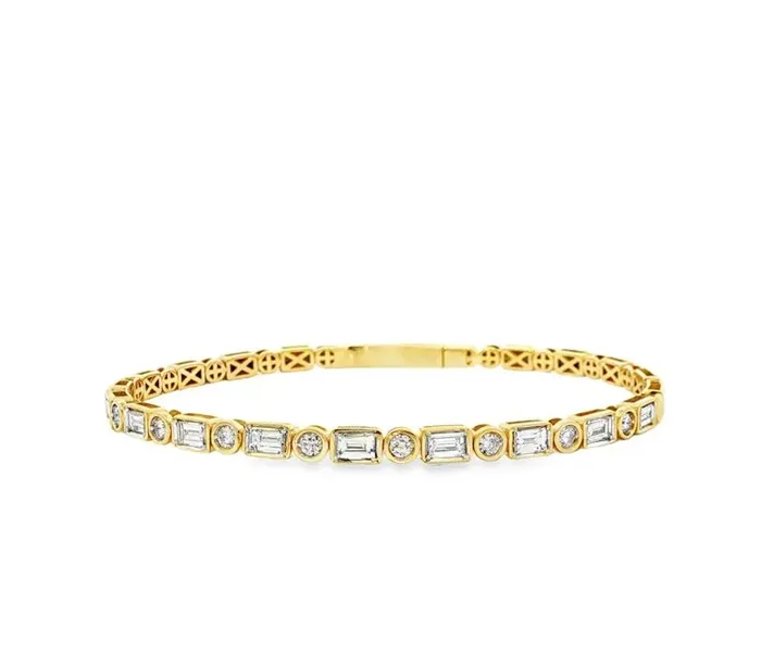 Elegant gold bracelet with rectangular and round diamonds, perfect for any occasion.