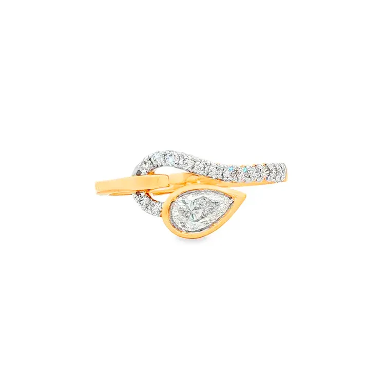 Gold ring with a pear-shaped diamond and sparkling accents.