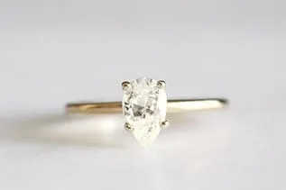 14k gold band with an emerald cut diamond