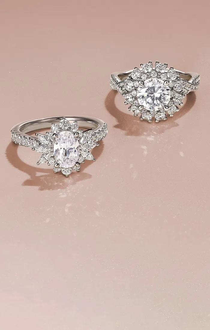 Two stunning diamond engagement rings on a soft pink background. Click to shop engagement rings at Snyder Jewelers.