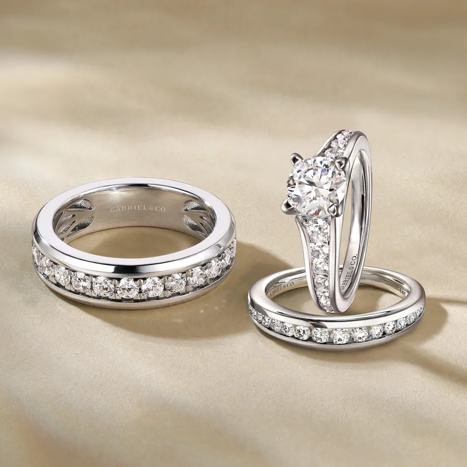 Three elegant Gabriel & Co. bridal rings featuring a diamond engagement ring and two matching wedding bands.