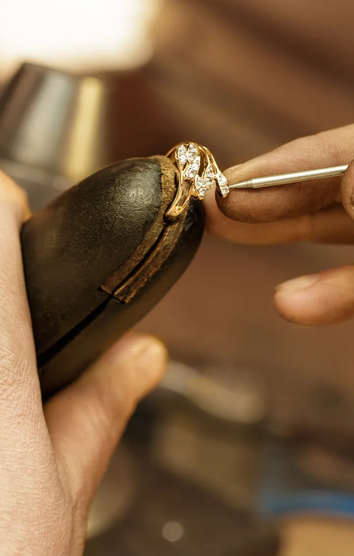 Jeweler restoring a diamond ring with precision tools at Synder Jewelers in Longmont. Learn more about our restoration services.
