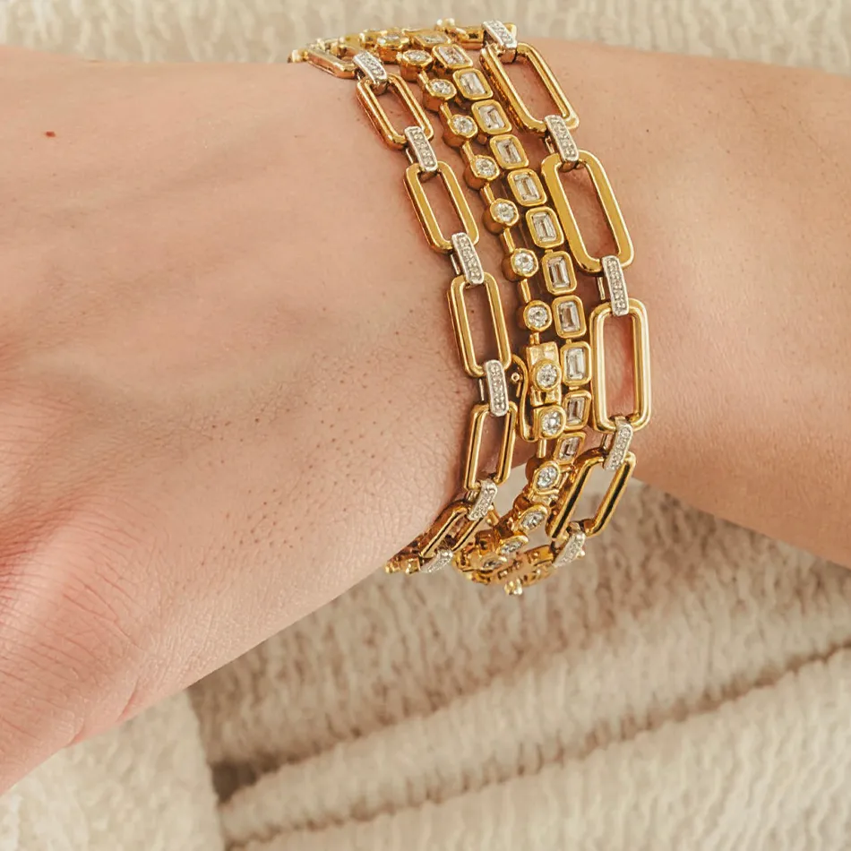 Gold and diamond bracelets stacked on a wrist, showcasing elegant jewelry from Synder Jewelers in Longmont.