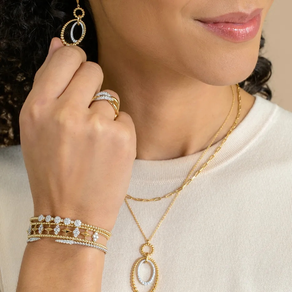 Model showcasing gold jewelry including earrings, rings, and bracelets from Synder Jewelers in Longmont.