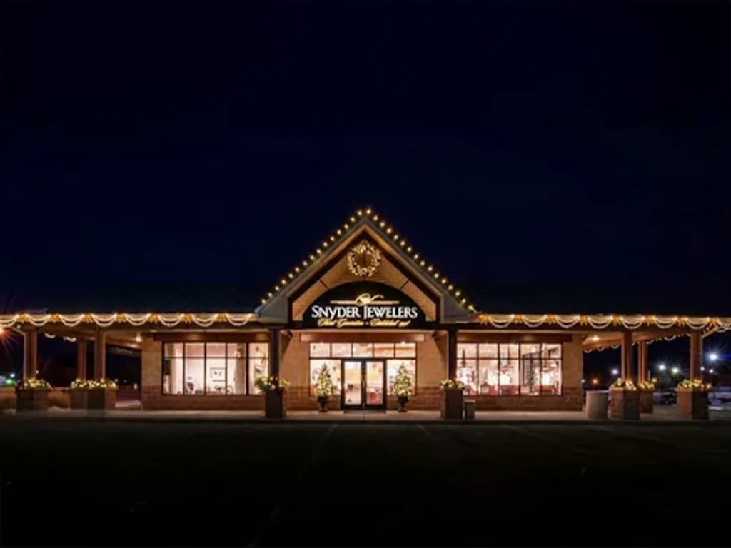 Interior of Snyder Jewelers in Longmont, showcasing customers interacting and various jewelry displays.