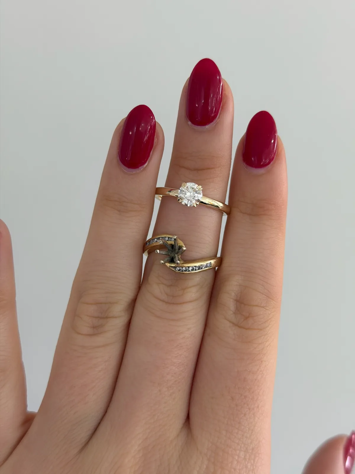 Round diamond redesign at SVS Fine Jewelry: the original channel set mounting with empty center below, and the finished claw prong yellow gold solitaire above