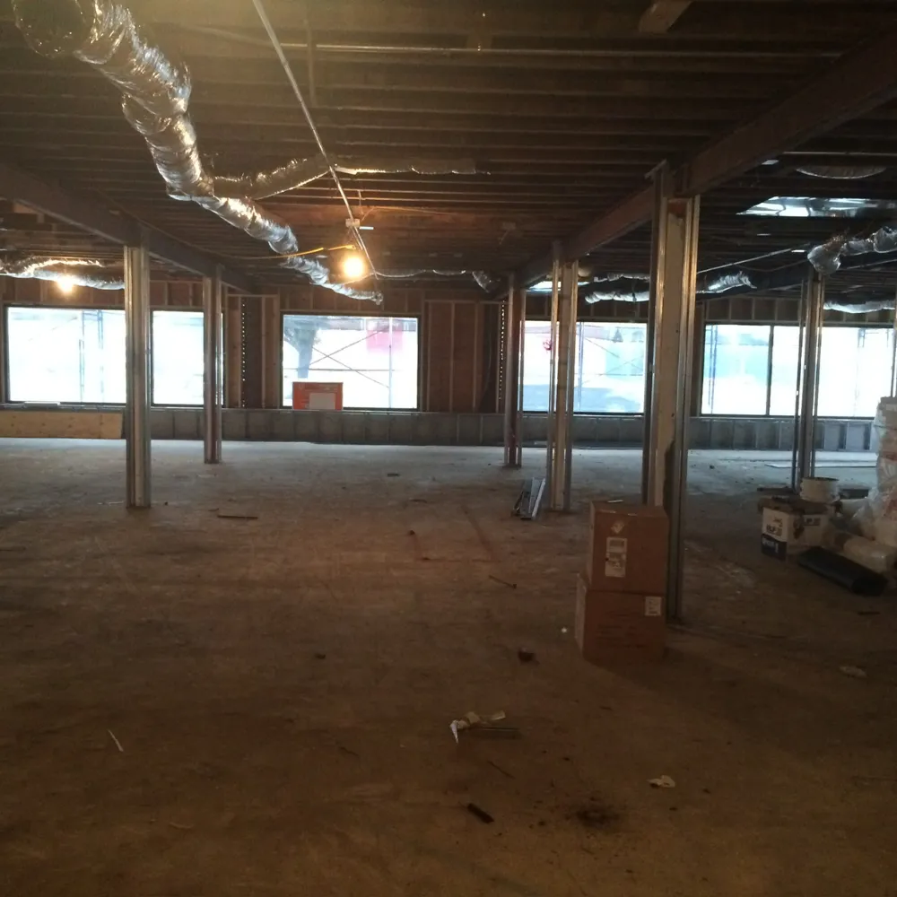 The 3323 Long Beach Road building stripped to the studs during the 2013 SVS Fine Jewelry construction &mdash; bare walls, exposed framing, no floors