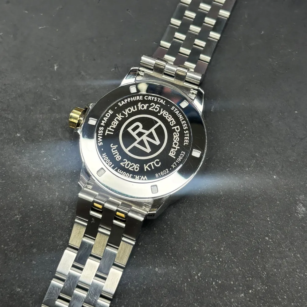 Reverse of a two-tone Raymond Weil wristwatch showing a custom engraving on the caseback