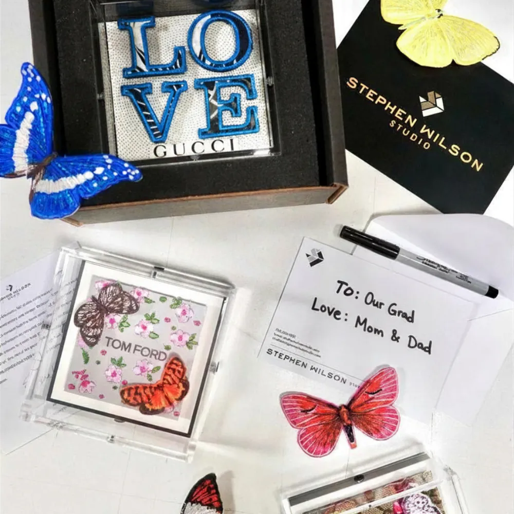 Stephen Wilson Studio custom embroidered art with handwritten 'To Our Grad, Love Mom and Dad' note — graduation gifts from SVS Fine Jewelry Long Island