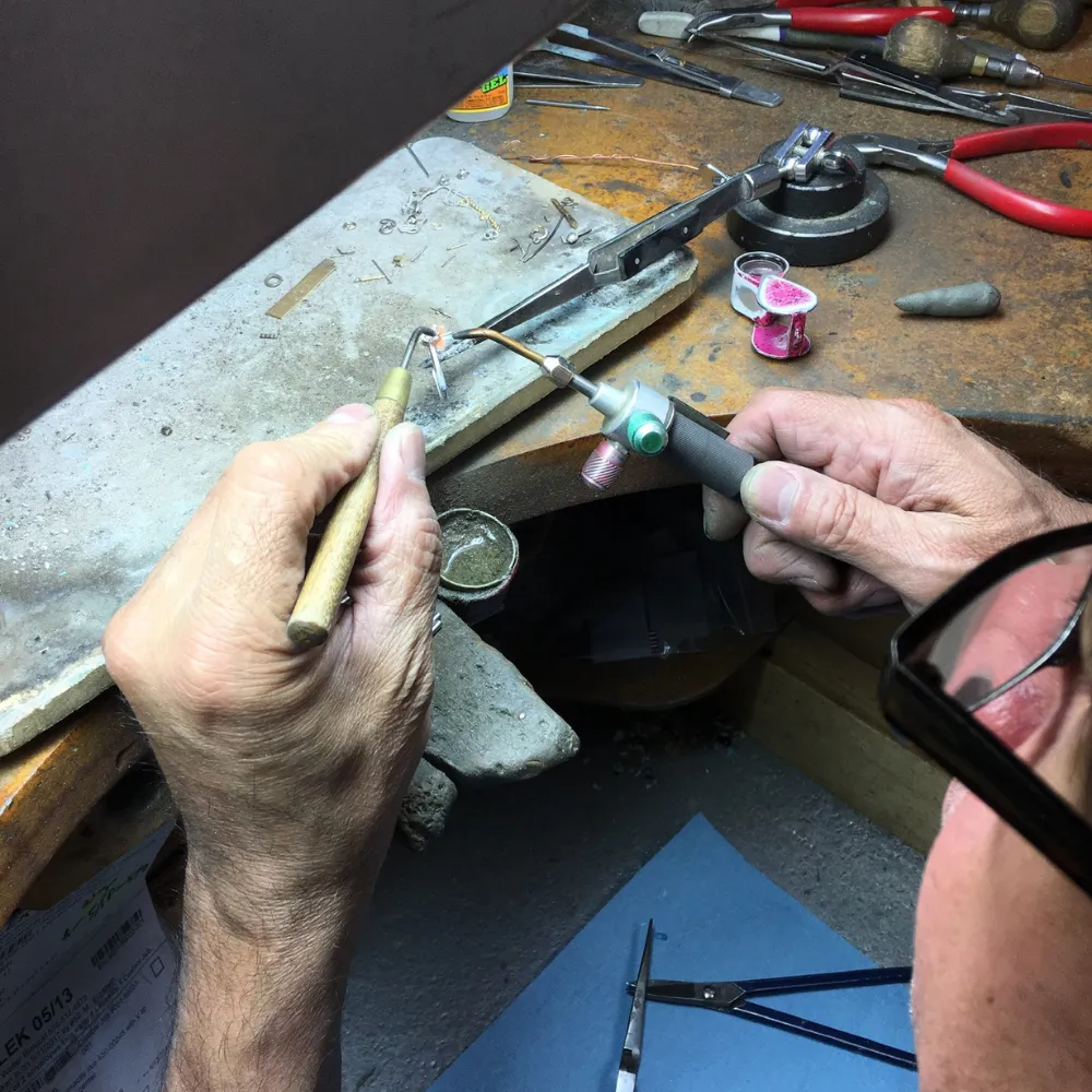 Jorge T., SVS Master Bench Jeweler, soldering at the workshop bench