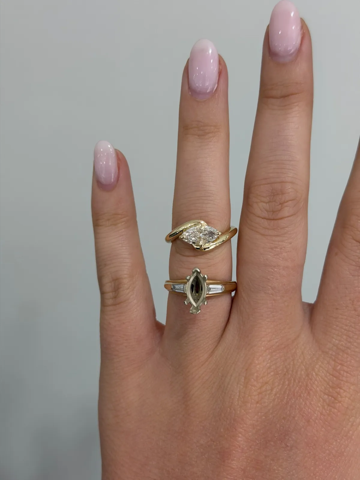 Marquise diamond redesign at SVS Fine Jewelry: the original marquise ring with baguette accents below, and the finished east west sculpted yellow gold setting above