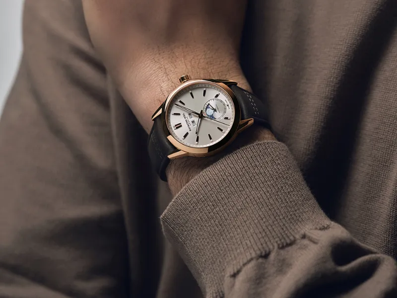 Men's gold watch on wrist with brown sleeve — Raymond Weil, G-SHOCK & Pre-Owned Rolex at SVS Fine Jewelry, Oceanside NY 