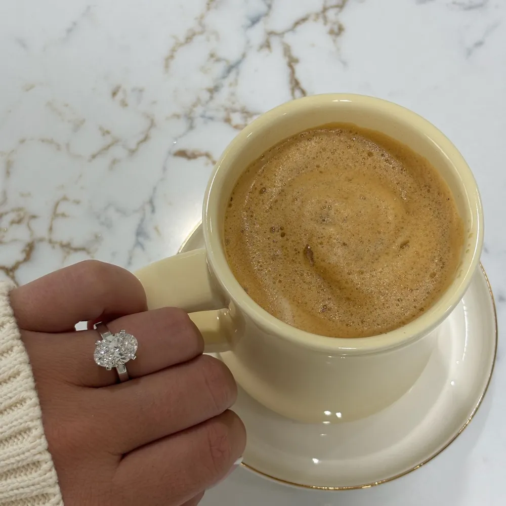Engagement ring on hand holding a fresh-brewed coffee at the SVS lounge