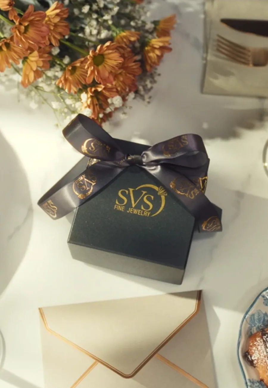 SVS Fine Jewelry signature gift box with gold monogram