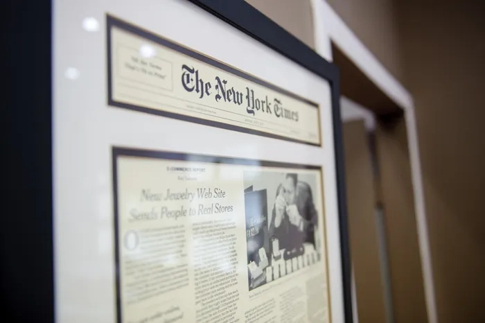 SVS Fine Jewelry featured in The New York Times — framed article displayed in our Oceanside, Long Island showroom