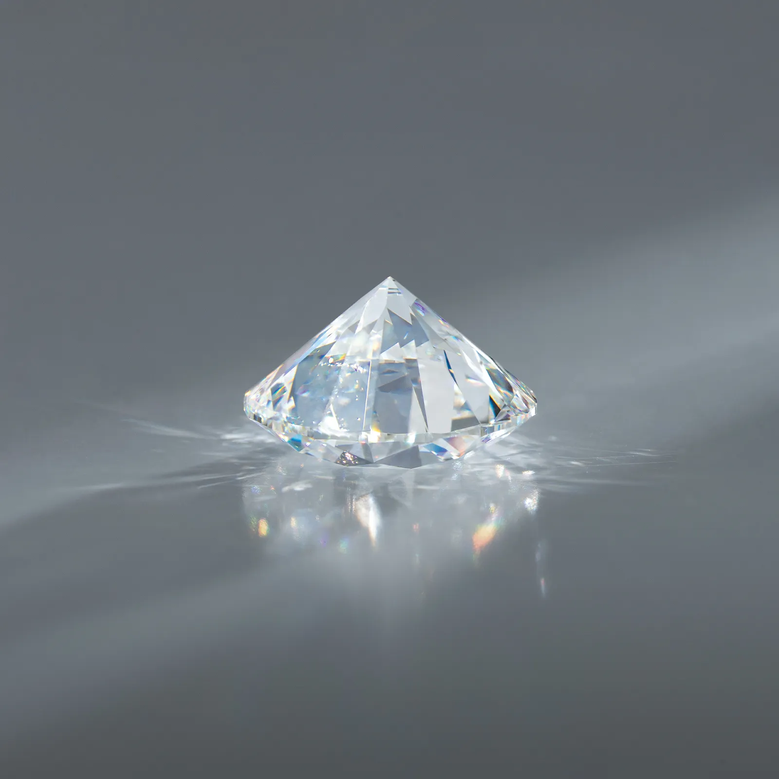 A sparkling lab-grown diamond on a reflective surface.