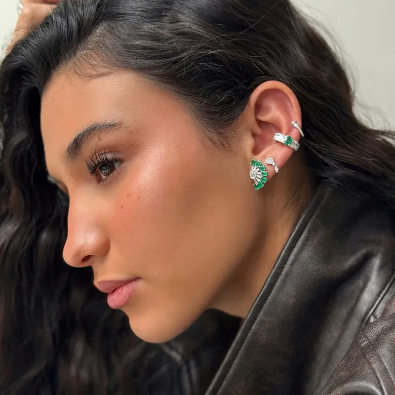 Model showcasing elegant earrings with emerald and diamond accent.