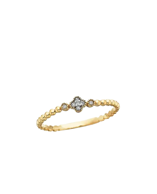 Delicate gold ring with a floral diamond centerpiece and smaller diamonds on each side, perfect for elegant occasions.