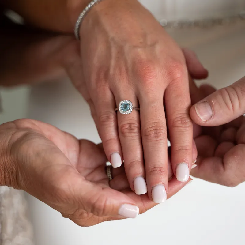 Hands displaying an engagement ring, symbolizing love and commitment.