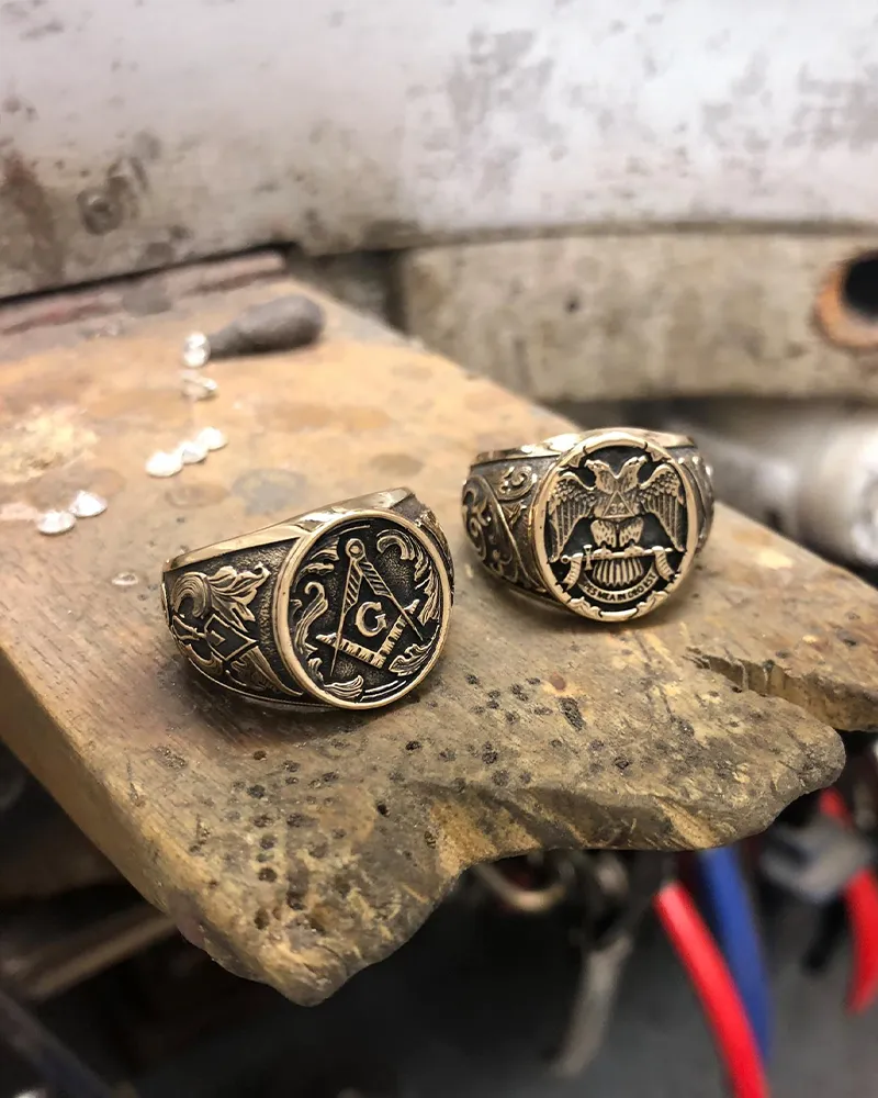 Elegant gold ring with a large emerald-cut center stone, accented by pink and white gemstones.