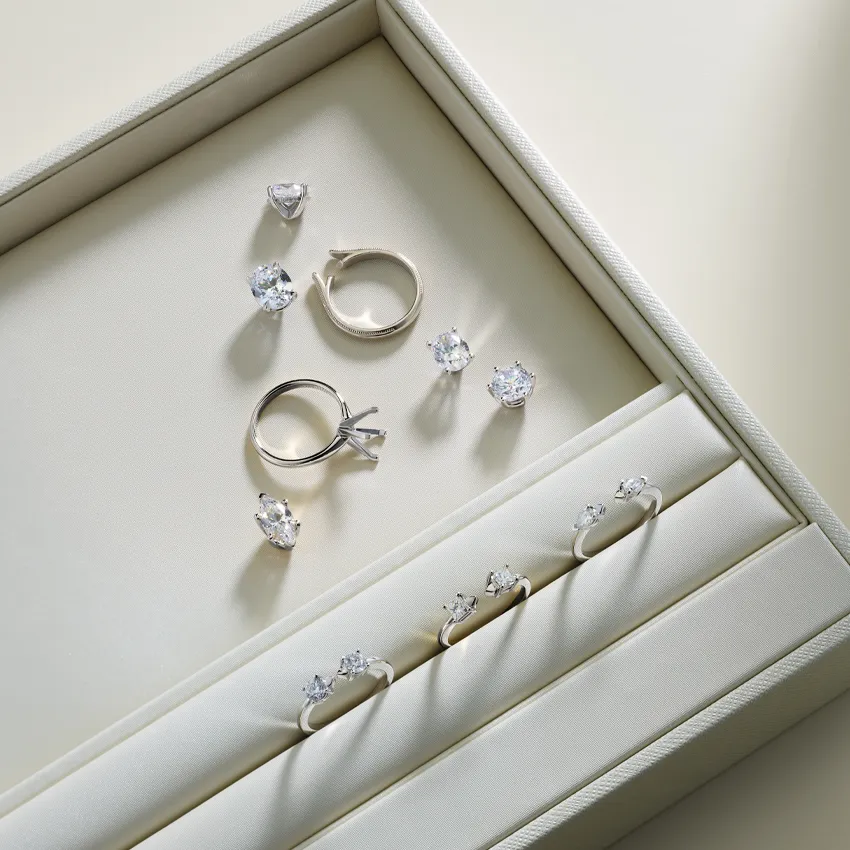 Elegant display of diamond rings and earrings in a jewelry box.