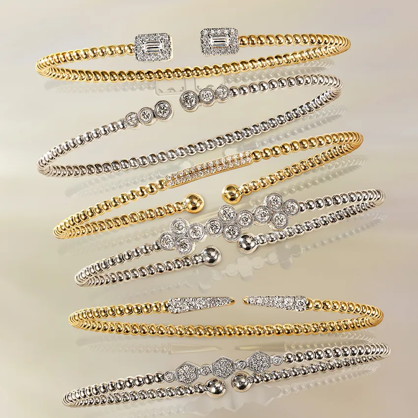 Elegant collection of gold and silver bracelets with diamond accents.