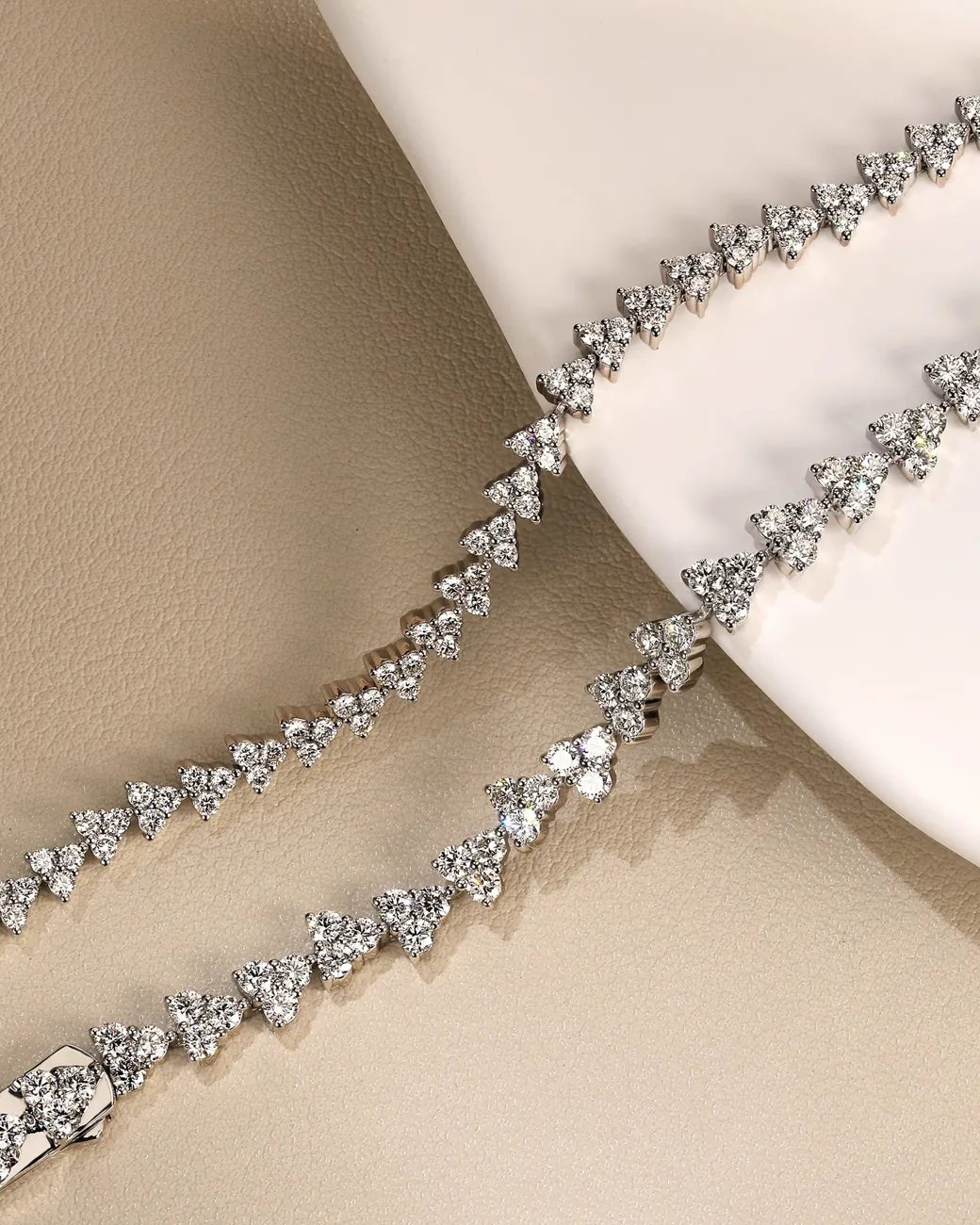 Sparkling diamond bracelet with triangular stones displayed elegantly on a neutral background.