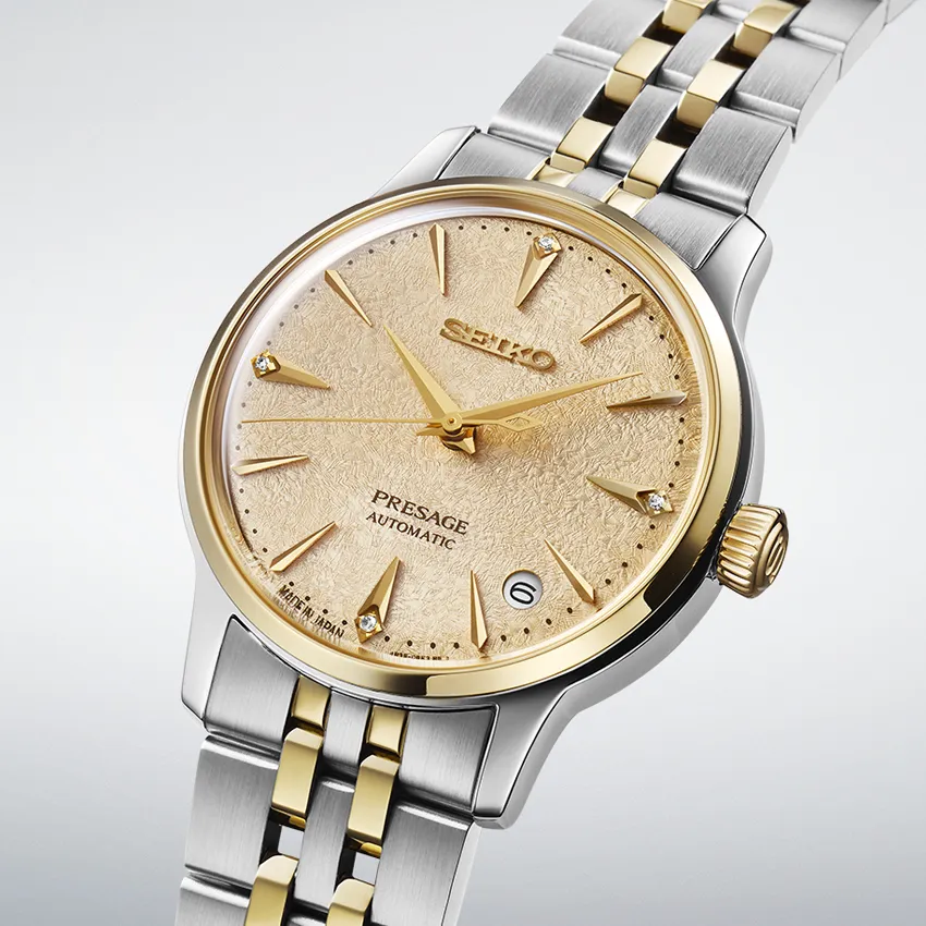 Seiko Presage automatic watch with gold-tone dial and two-tone bracelet.