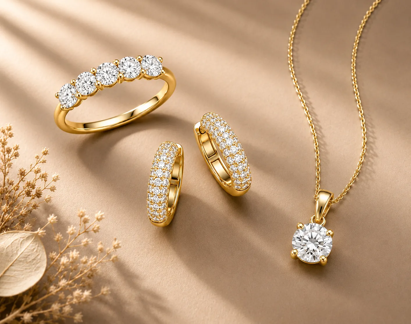 Yellow gold diamond jewelry with five-stone ring, hoop earrings, and solitaire pendant.