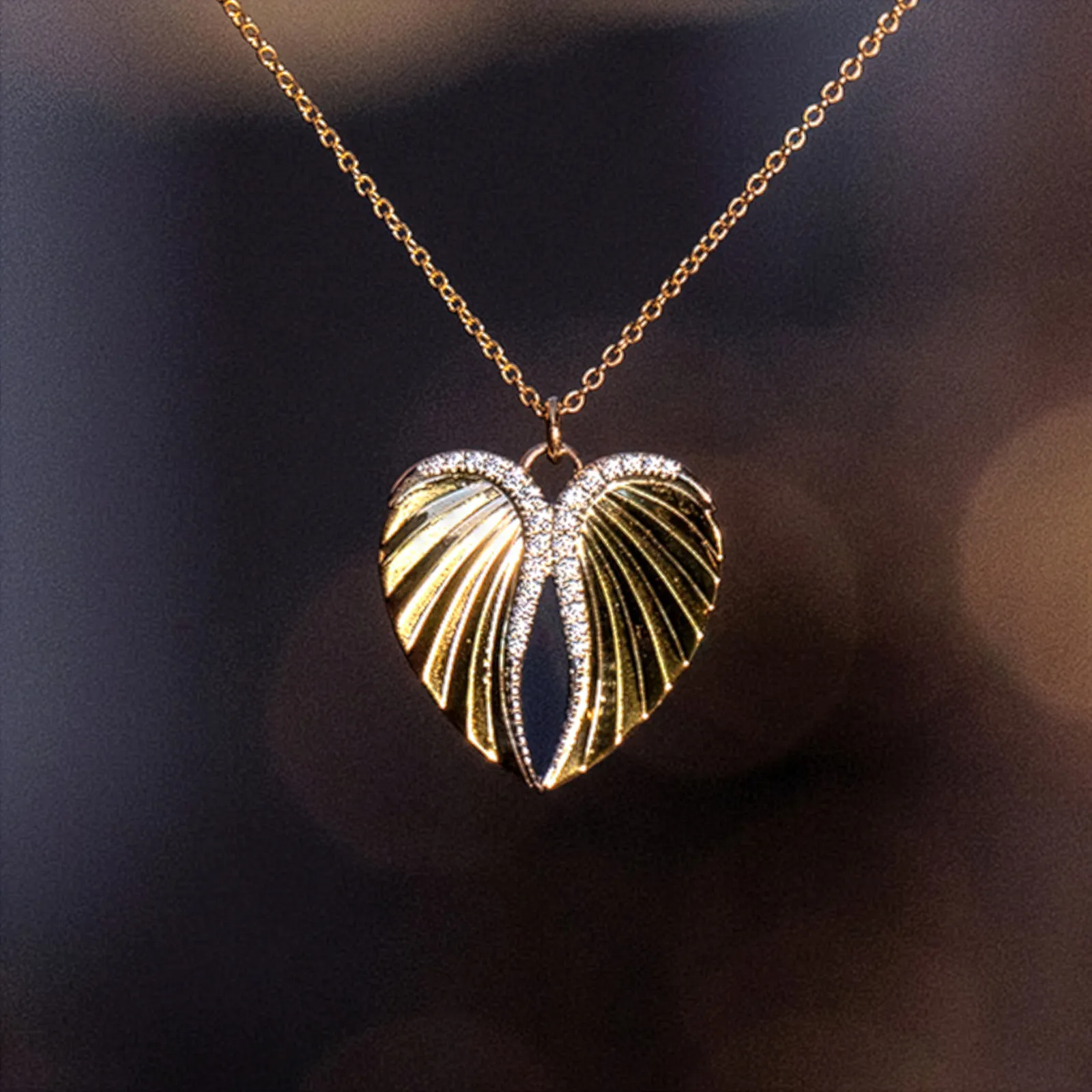 Couple sharing a romantic moment, holding a heart cutout and a gift, celebrating love together.