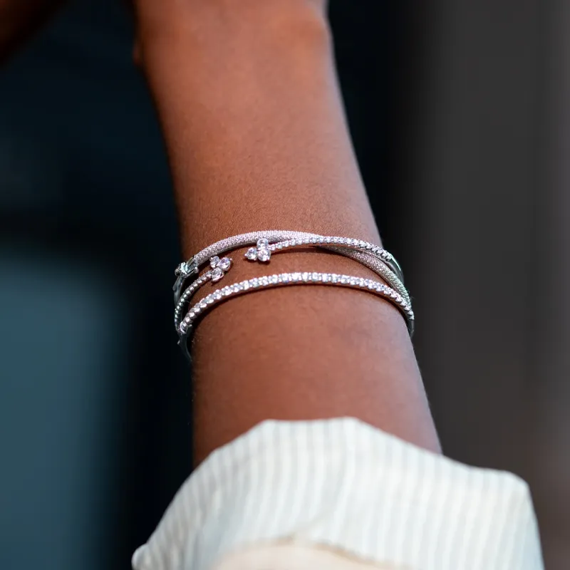 Three elegant diamond bracelets on a wrist, showcasing fine jewelry. Click to SHOP NOW at The Diamond Shop, Inc. in Lewiston.