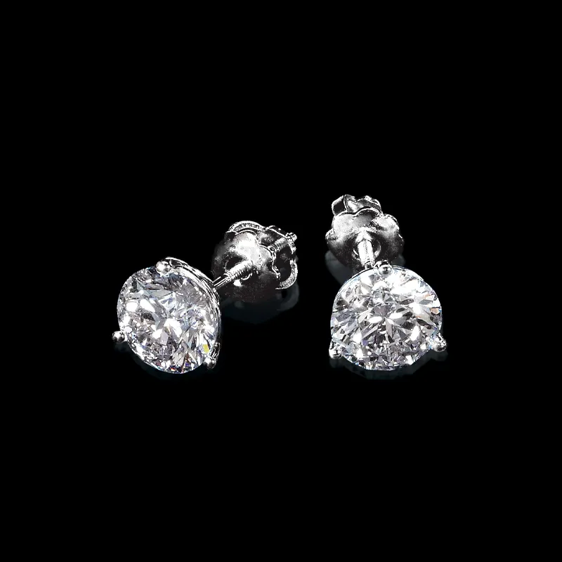 Diamond stud earrings with a sparkling design, displayed on a black background.