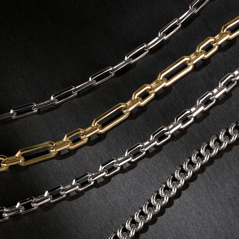 Three stylish chains in silver and gold on a dark background. 
