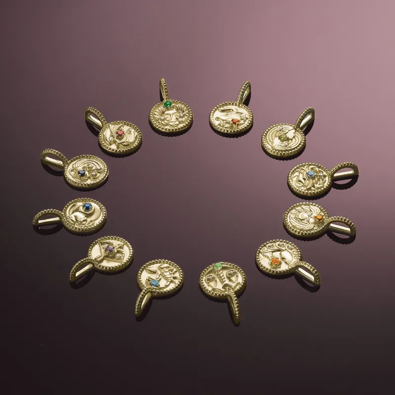 Gold charms with colorful gemstones arranged in a circular pattern.
