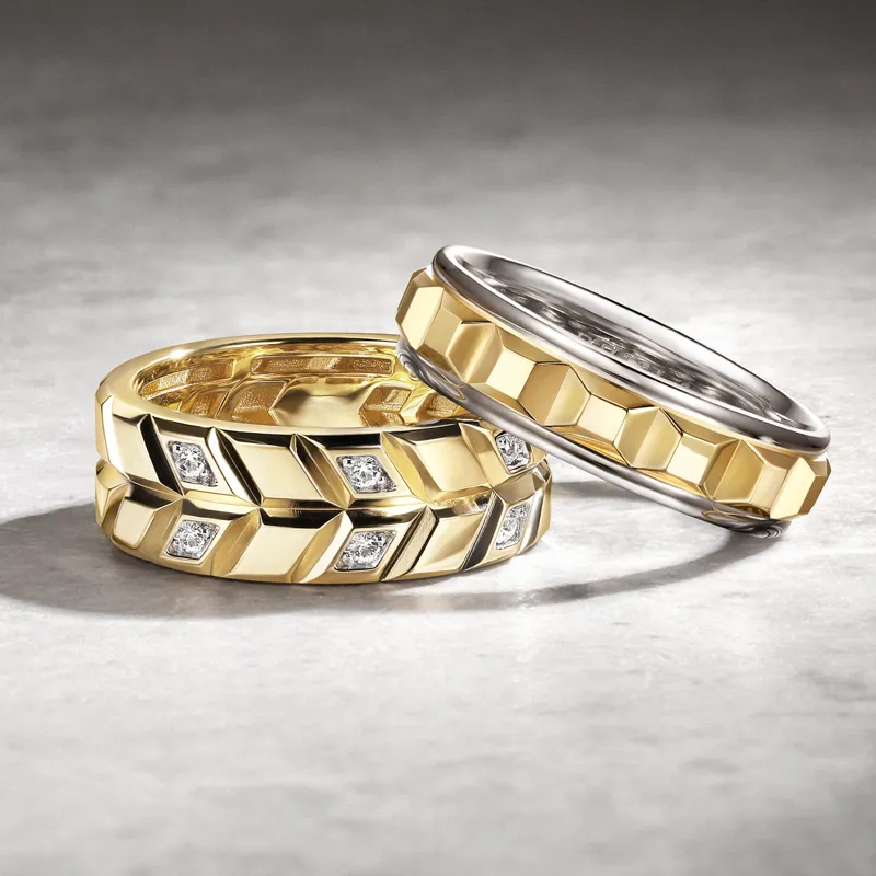 Three stylish wedding bands: two gold bands with geometric designs and one silver band, showcasing elegance.
