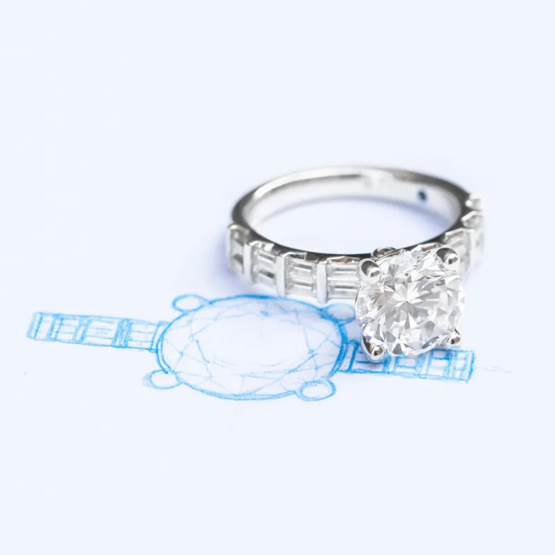 Diamond engagement ring on a sketch, showcasing custom design. Click to learn more about custom jewelry at The Diamond Shop.