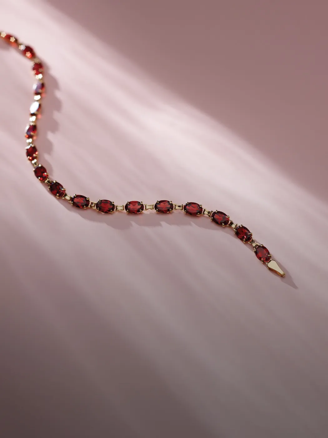 Elegant gemstone bracelet with red stones, perfect for any occasion.