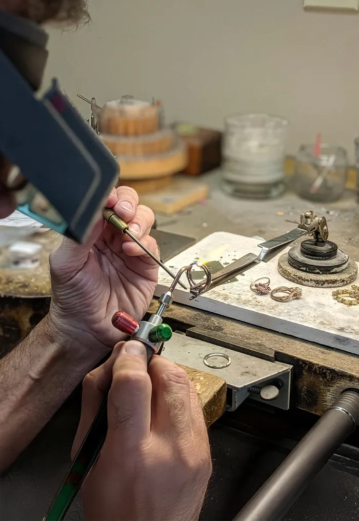 Jeweler using a torch to repair a ring at T.J.'s Fine Jewelry in Carbondale, IL.