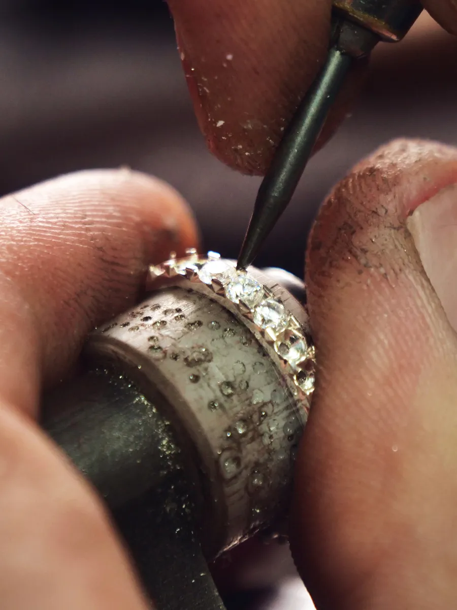 Jeweler meticulously setting diamonds on a ring at T.J.'s Fine Jewelry in Carbondale, IL.