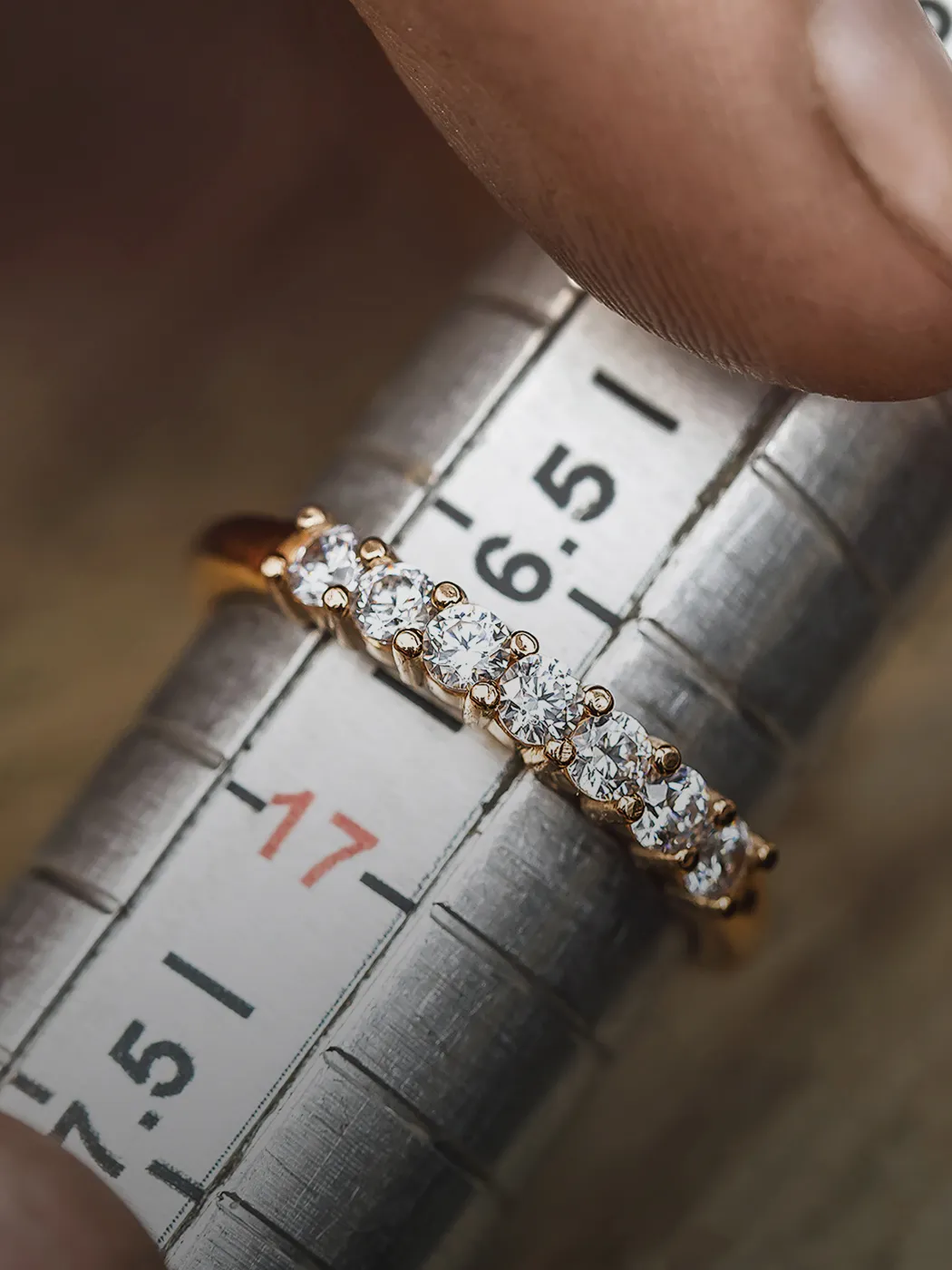 Close-up of a diamond ring being measured for resizing on a ring sizer at T.J.'s Fine Jewelry in Carbondale, IL.