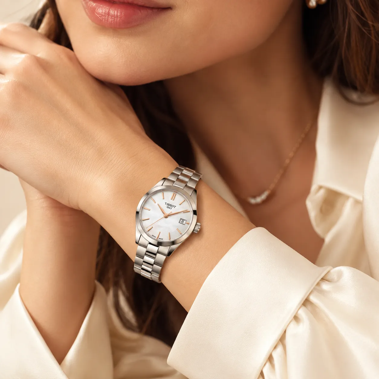 Gold watch with a diamond-studded face worn on a wrist, showcasing elegance and style.