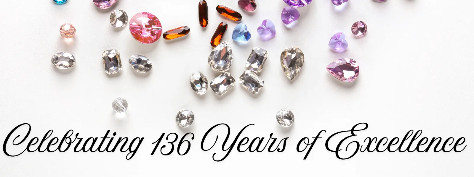 Colorful gemstones scattered on a white background with the text 